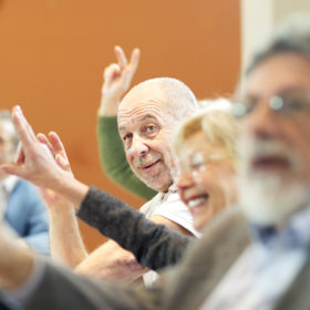 Seniors on seminar raising hands